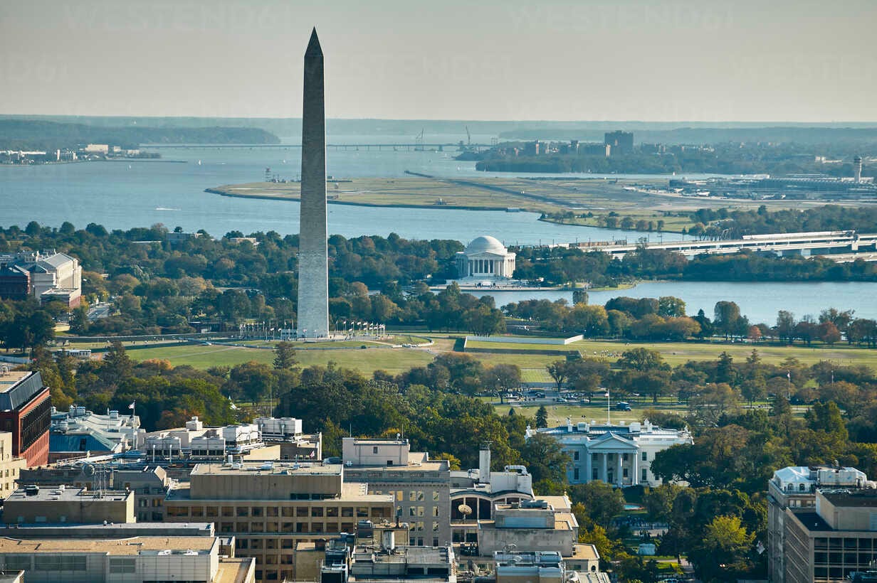 A view from a tall building of the Potomac River with the Washington Monument and the White House in the foreground. 