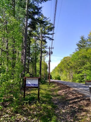 MegaPrint sign by highway surrounded by trees