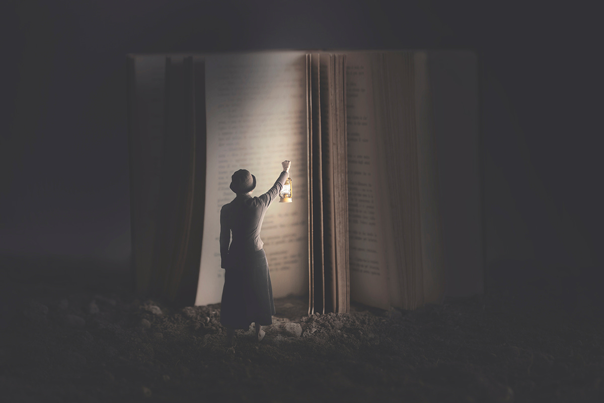 Woman Holding Lamp up to Illuminate Giant Book