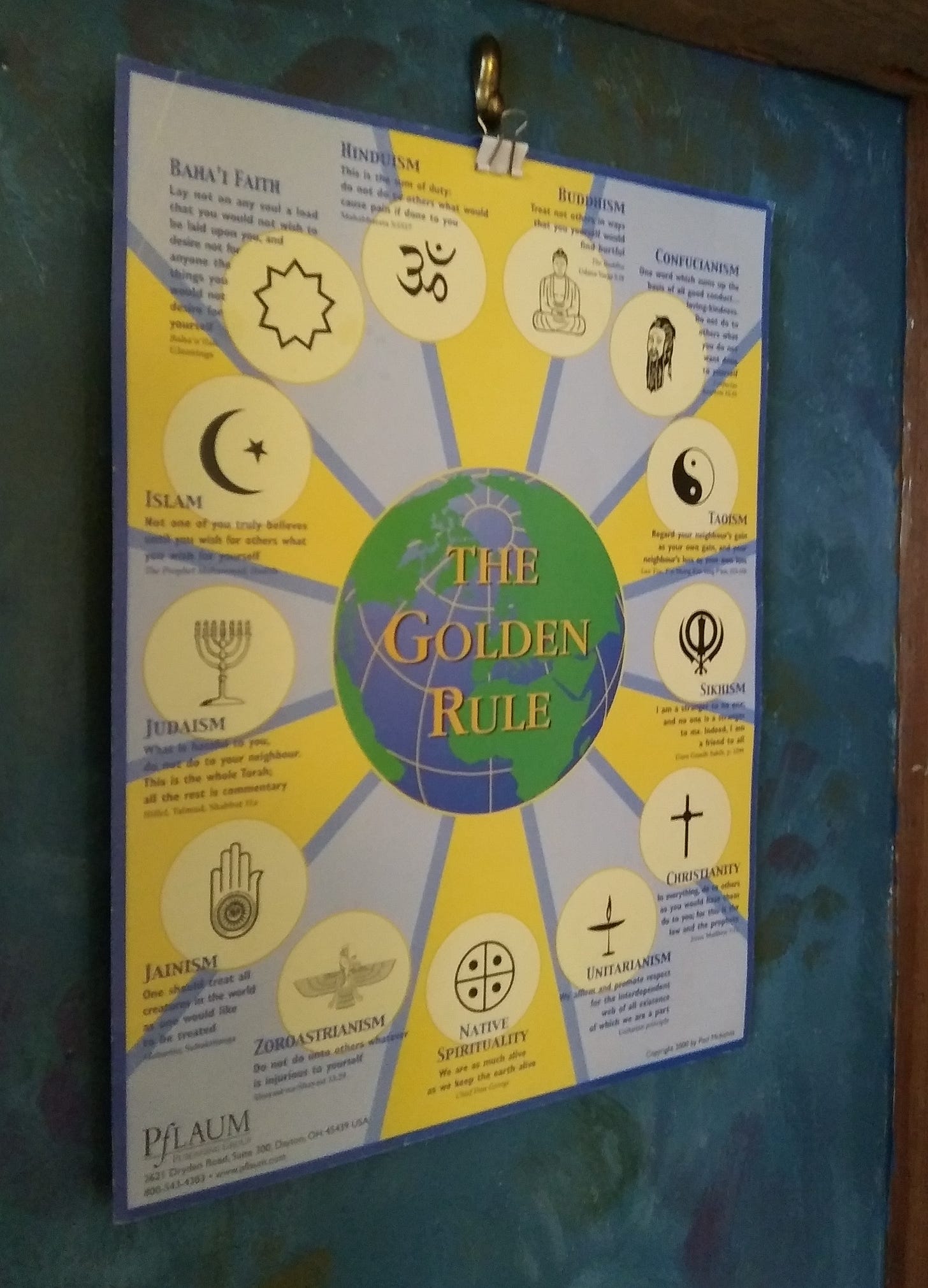 A photo of a poster showing the Golden Rule in the sacred writings of 13 faiths.