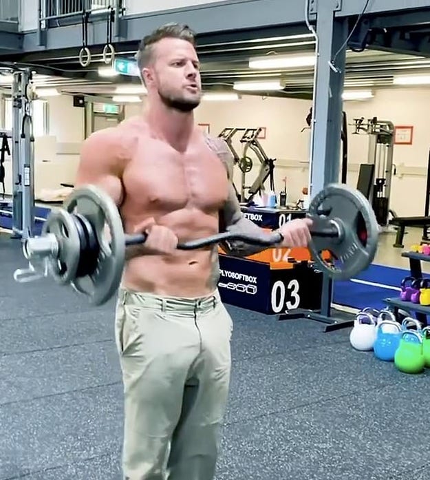 Photo of Bobby Holland Hanton doing a barbell curl in a gym
