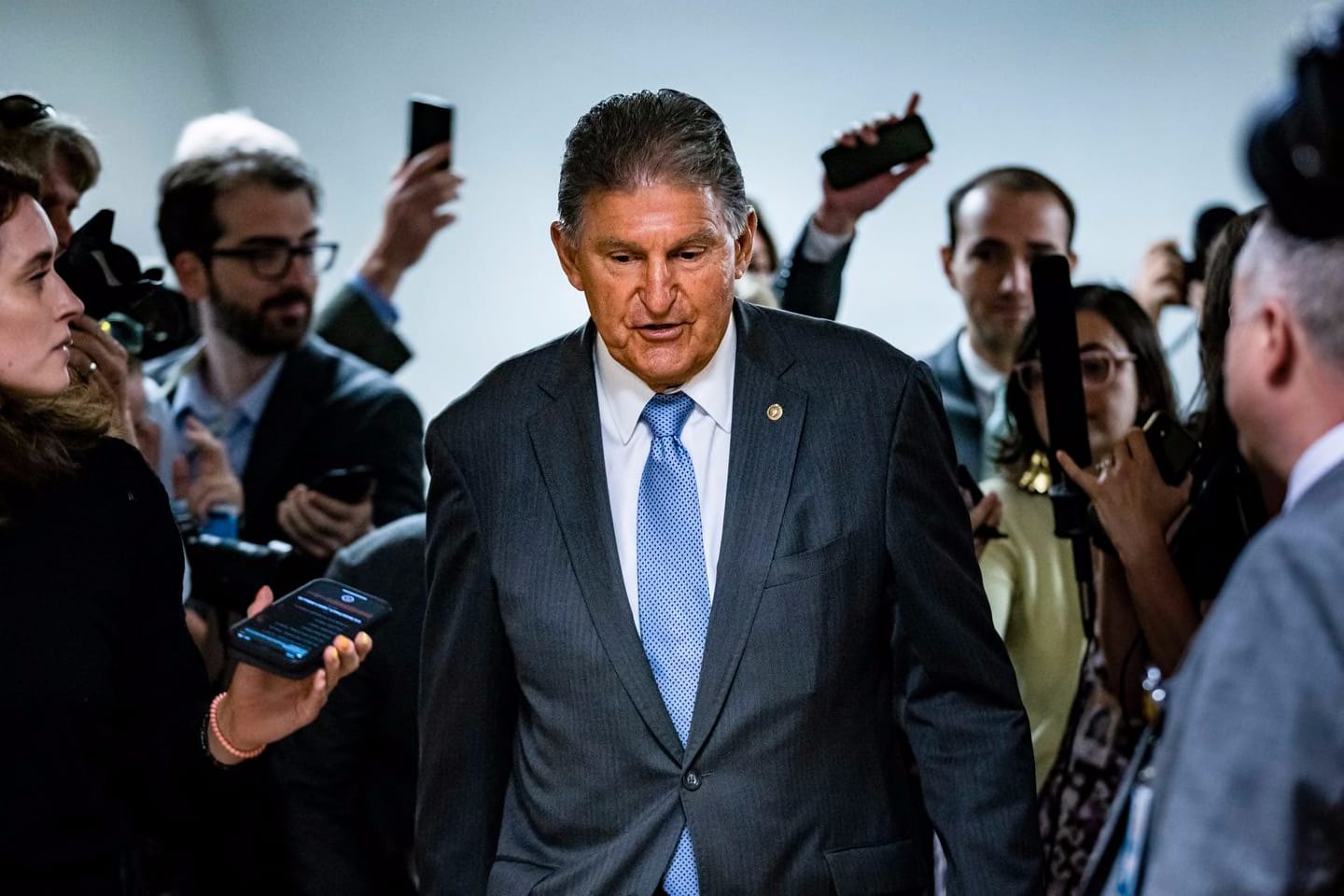 Senator Joe Manchin, Democrat of West Virginia, was surrounded by reporters as he headed to a vote in the Senate at the US Capitol on June 8. The spotlight on Manchin is growing even brighter now that he is the lone Democratic holdout on the party's voting rights legislation.