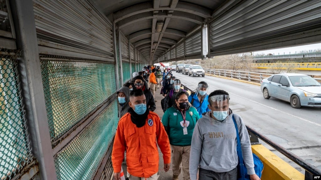 Migrants approach the U.S. border on Gateway International Bridge in Brownsville, Texas on March 2, 2021.