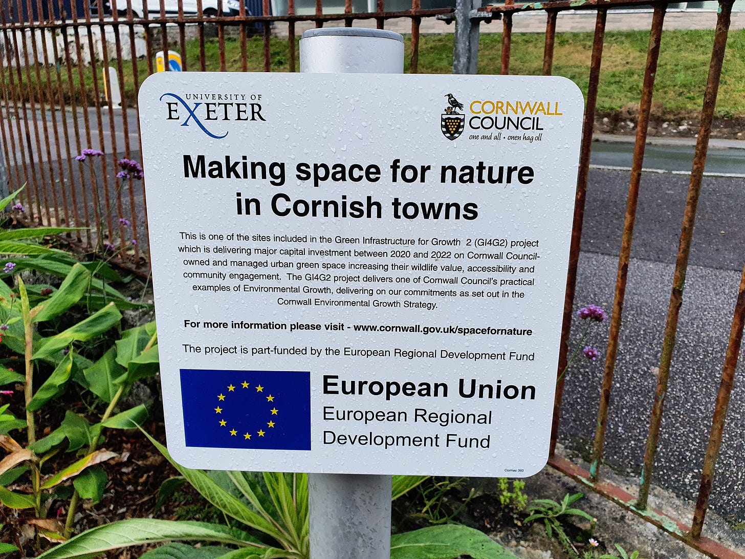 Plaque bearing the logos of Exeter University and Cornwall Council, with text reading "Making space for nature in Cornish towns: This is one of the sites included in the Green Infrastructure for Growth (GI4G2) project which is delivering major capital investment between 2020 and 2022 on Cornwall Council-owned and managed urban green space increasing their wildlife value, accessibility and community engagement. The GI4G2 project delivers one of Cornwall Council’s practical examples of Environmental Growth, delivering on our commitments as set out in the Cornwall Environmental Growth Strategy." An EU logo is accompanied by text reading: "The project is part-funded by the European Regional Development Fund."
