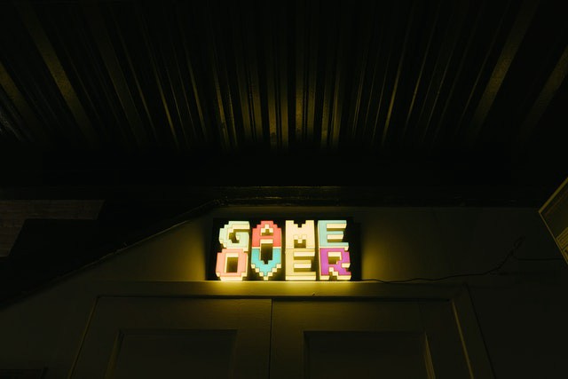A neon sign saying game over