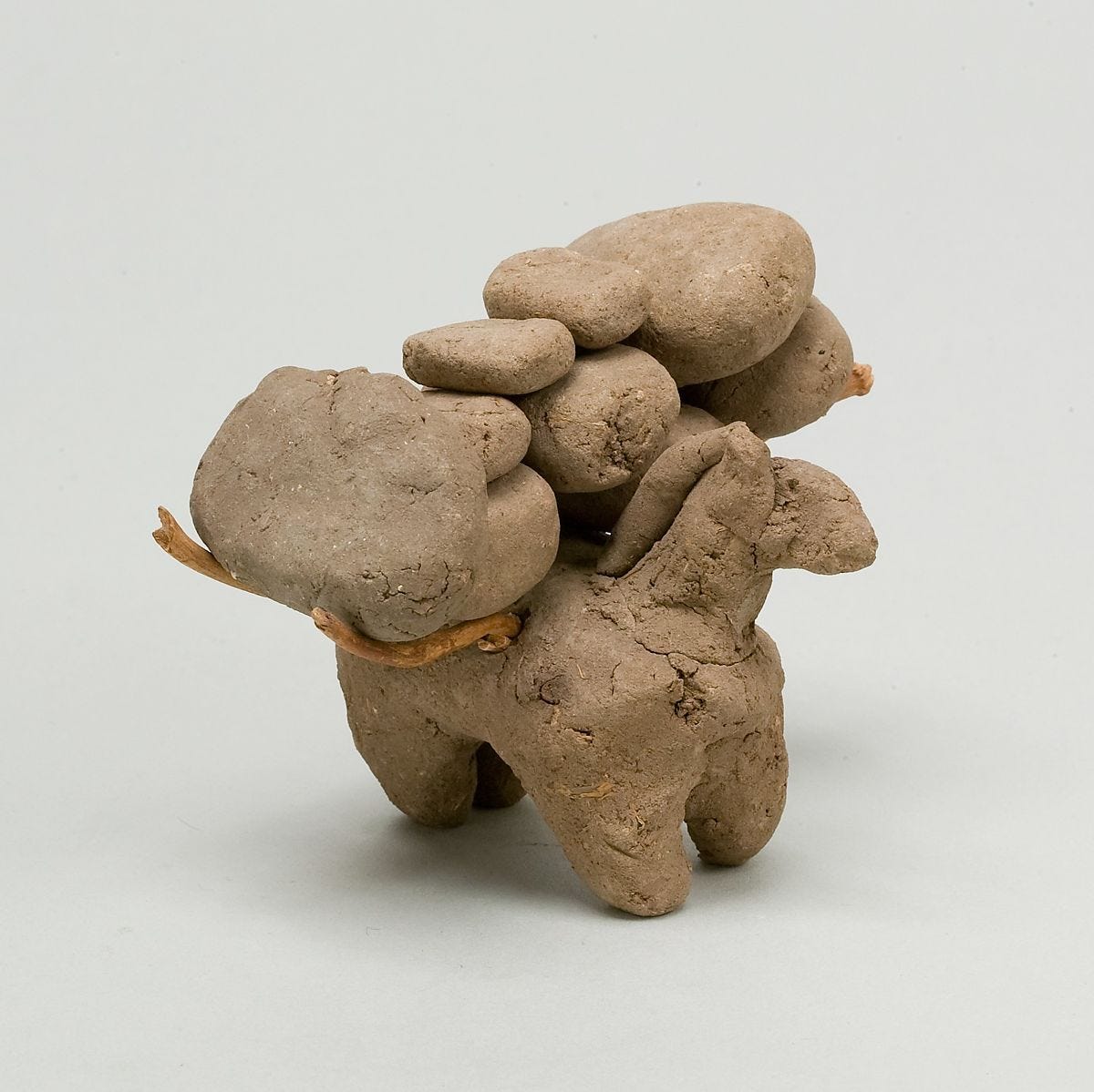 Donkey with packs on its back, Clay, twigs 