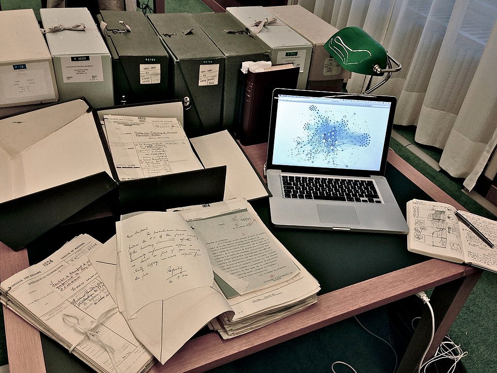 Historian's desk with manuscripts and computer