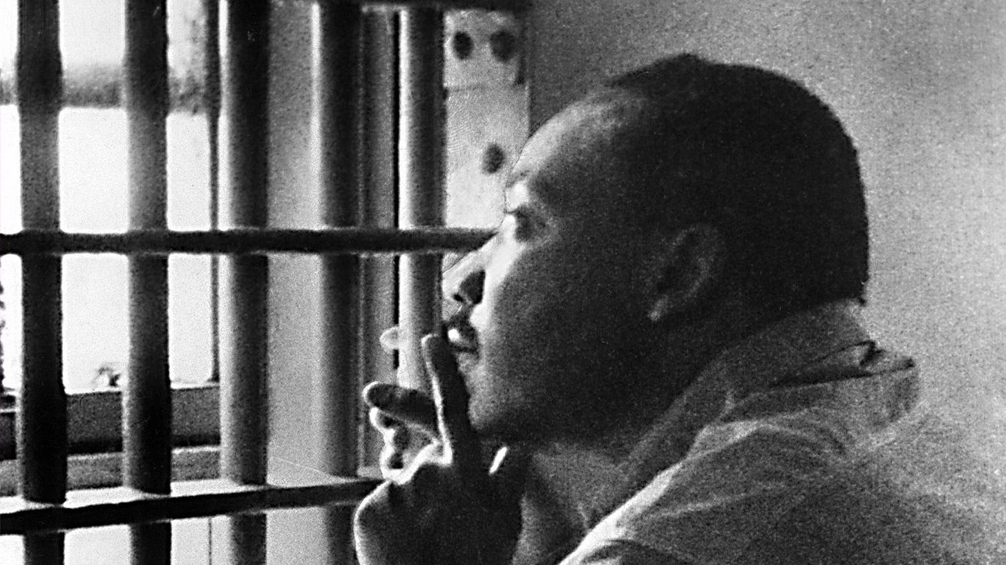 MLK in a jail cell looking through the cell bars