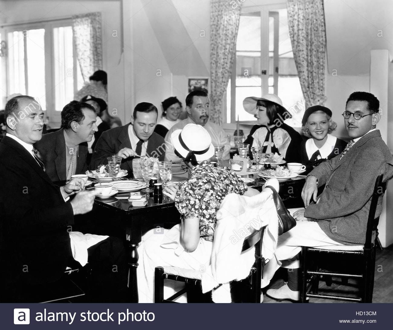 black and white photo of a group of film people at dinner, including Harry Lachman, Warner Oland, and Quon Tai Lachman