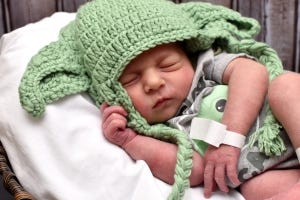 Photo of my newborn daughter in a yoda cap
