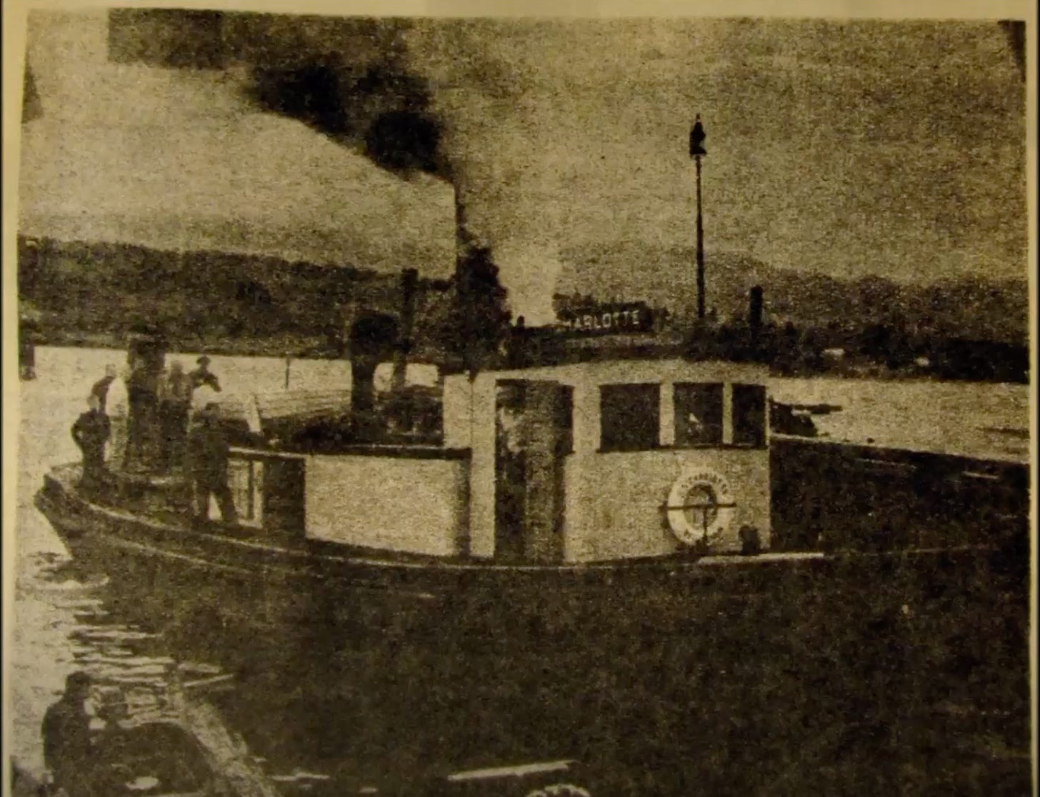 Vintage sepia photo of the Charlotte with steam out its stack, people at its aft