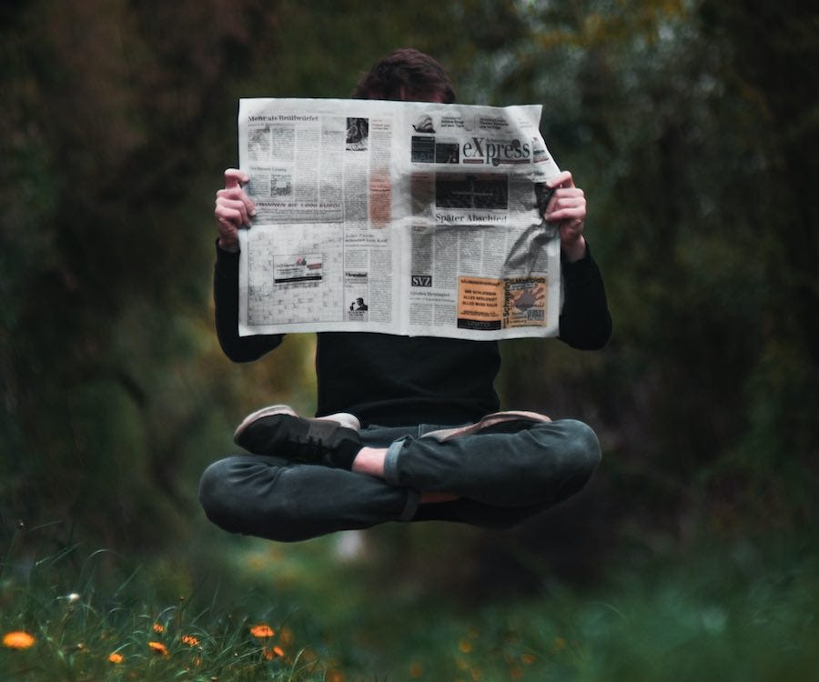 Reading a newspaper while floating