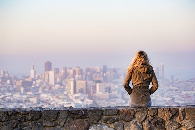 back of person sitting and looking over the San Francisco skyline