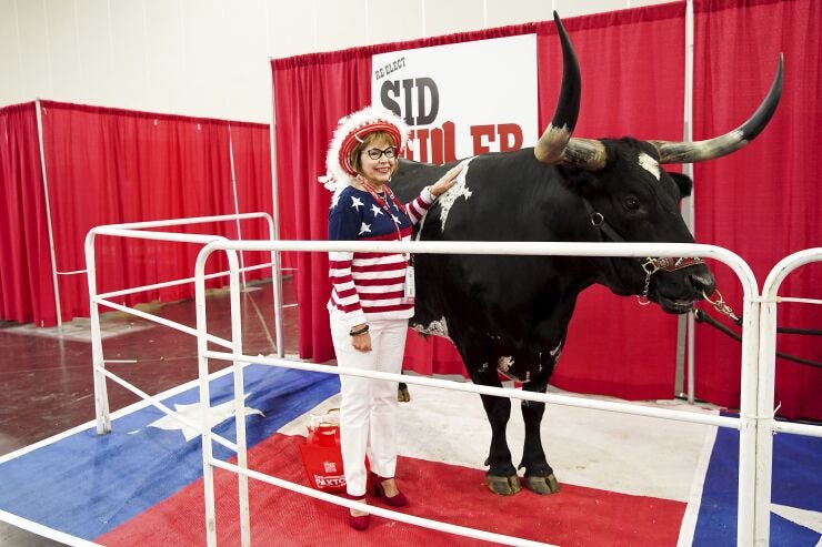 Elaine Wilmore poses with longhorn display for Republican Party of Texas convention.