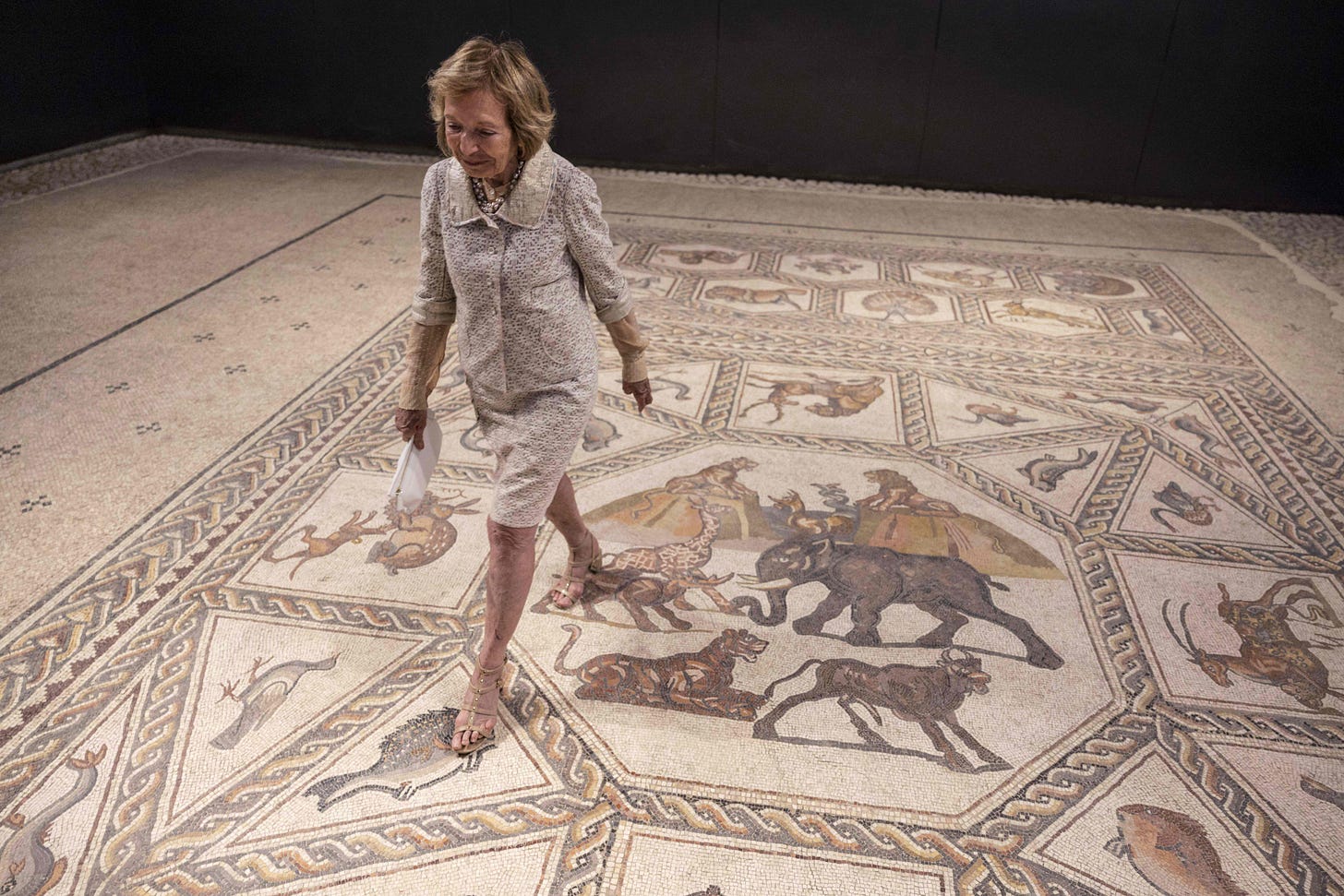 Shelby White walking on a mosaic