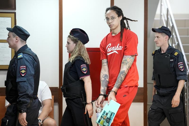 FILE - WNBA star and two-time Olympic gold medalist Brittney Griner is escorted to a courtroom for a hearing, in Khimki outside Moscow, Russia, Thursday, July 7, 2022. Closing arguments in Brittney Griner's cannabis possession case in Russia are set for Thursday. That's nearly six months after the American basketball star was arrested at a Moscow airport in a case that has reached the highest levels of U.S.-Russia diplomacy. (AP Photo/Alexander Zemlianichenko, File)