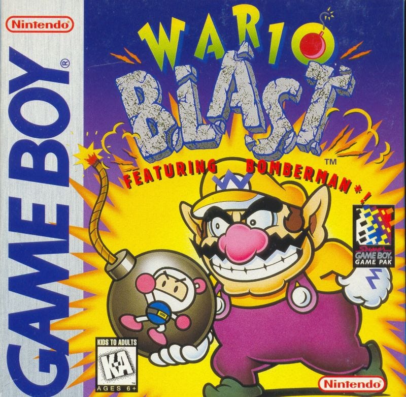 The North American box art for Wario Blast: Featuring Bomberman!, which focuses on a smiling Wario holding a bomb with Bomberman on it.