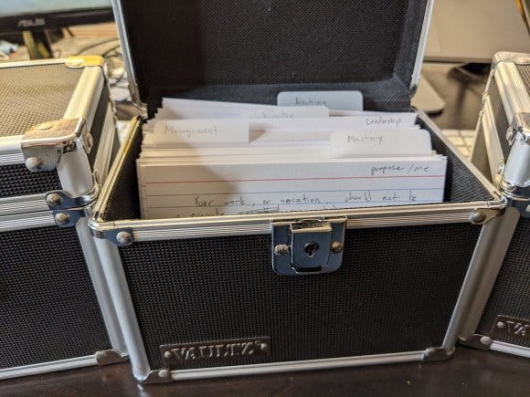 Notecards organized in a storage container.