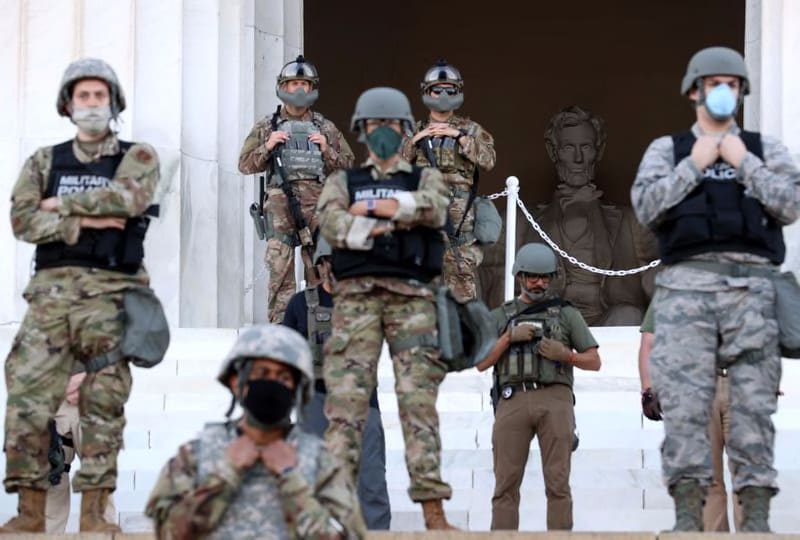 Members of the D.C. National Guard stand on the steps of the Lincoln Memorial monitoring demonstrators during a peaceful protest against police brutality and the death of George Floyd. President Trump tweeted Sunday that he had ordered the National Guard to withdraw from Washington D.C.