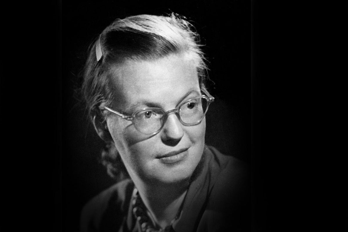 Shirley Jackson, a while woman with glasses and neatly braided hair. 