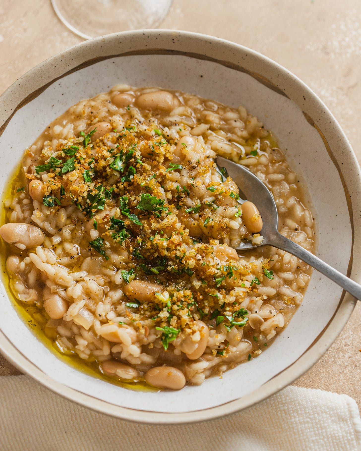 close-up shot of risotto with white beans and crispy herb breadcrumbs