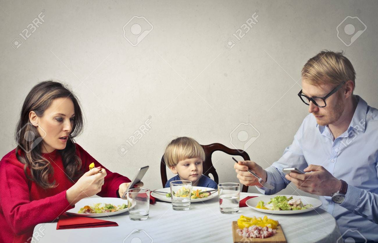 Family Are Typing On Their Phone During Dinner Stock Photo, Picture And  Royalty Free Image. Image 81241229.