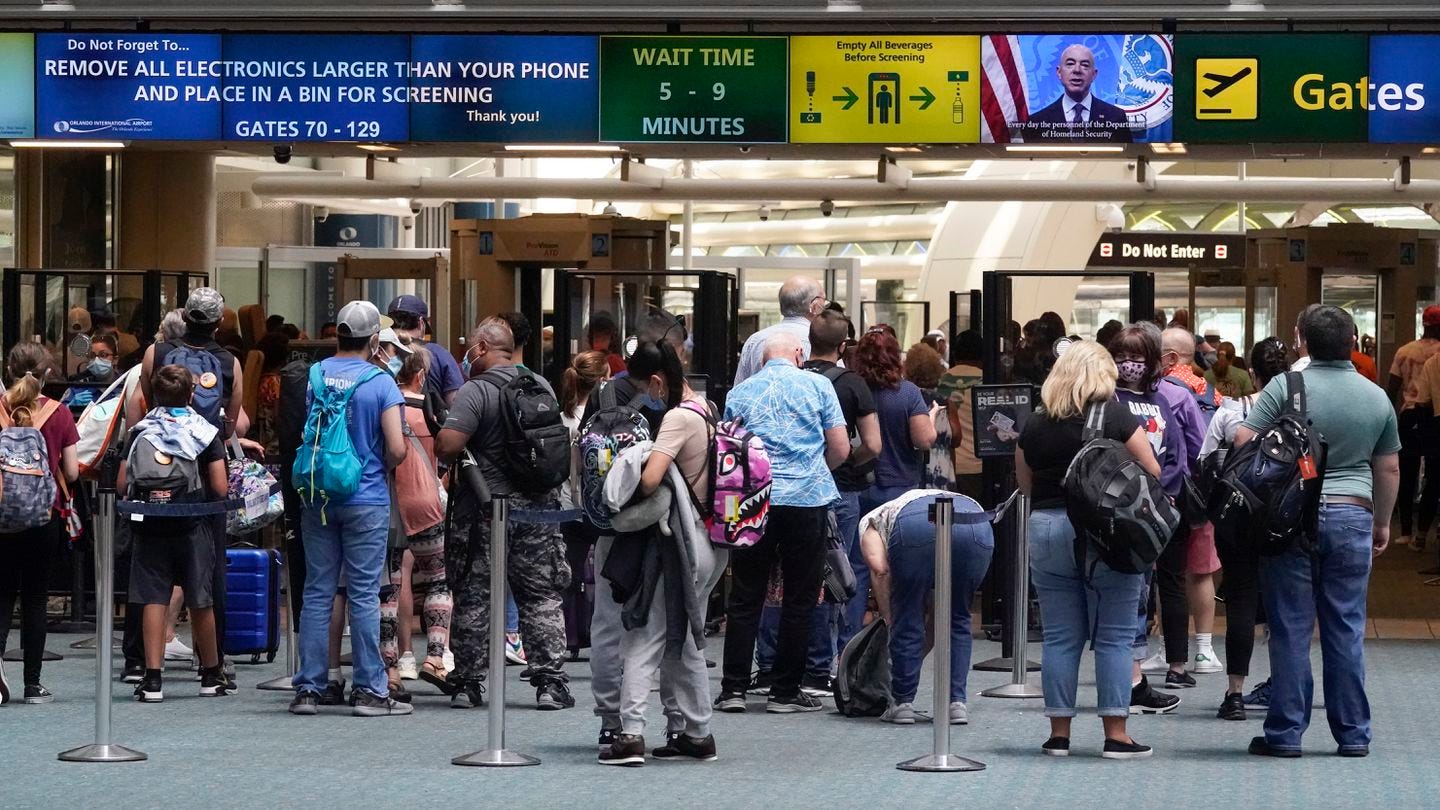 Travelers lined up to go through a TSA checkpoint at Orlando International Airport before the Memorial Day weekend.