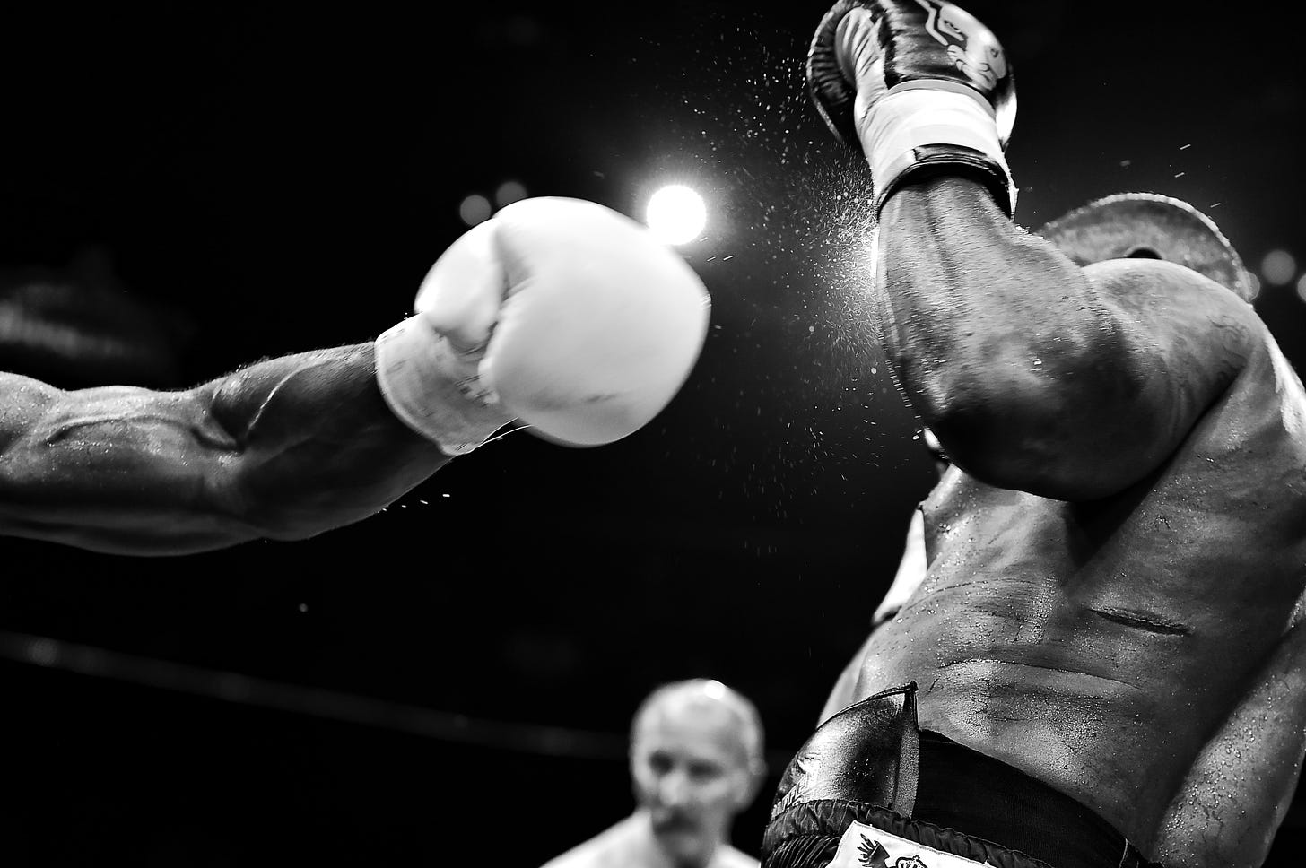 Boxer being hit by arm with white glove