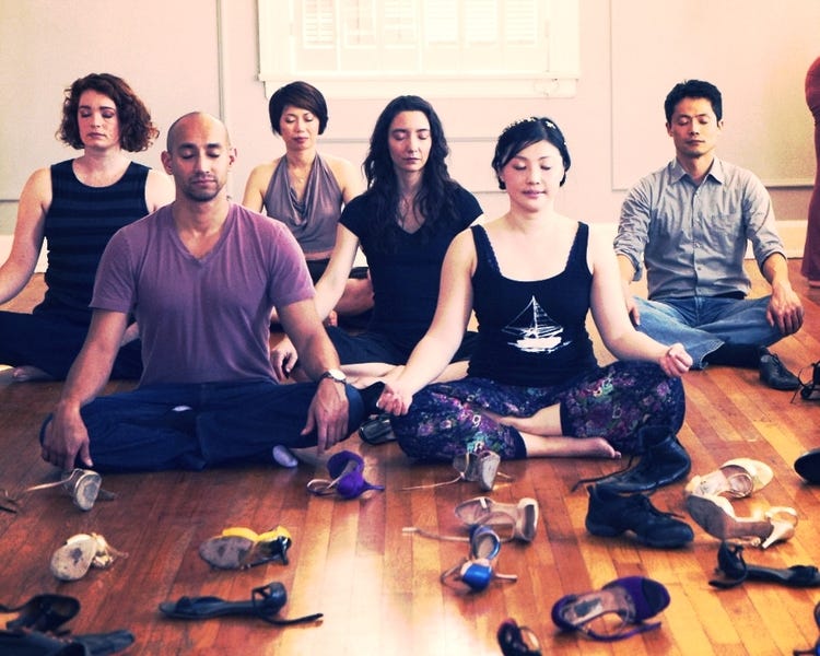 a group of people meditating