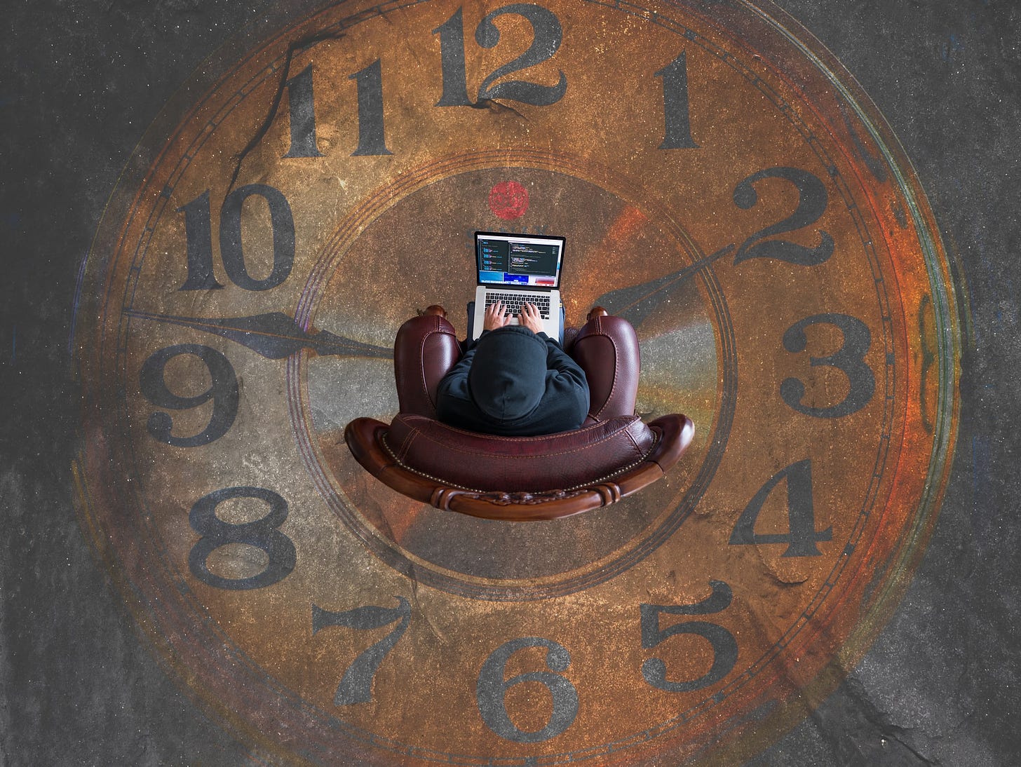Person sitting in a chair on a clock face painted on the floor.