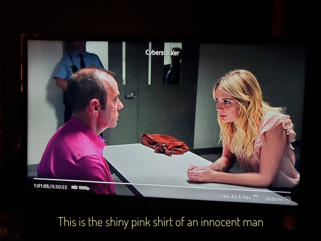 Aiden and Winton talking in an interrogation room, captioned "this is the shiny pink shirt of an innocent man"