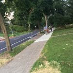 Another bicyclist with kid still chooses to use the sidewalk rather than the new bike lane.