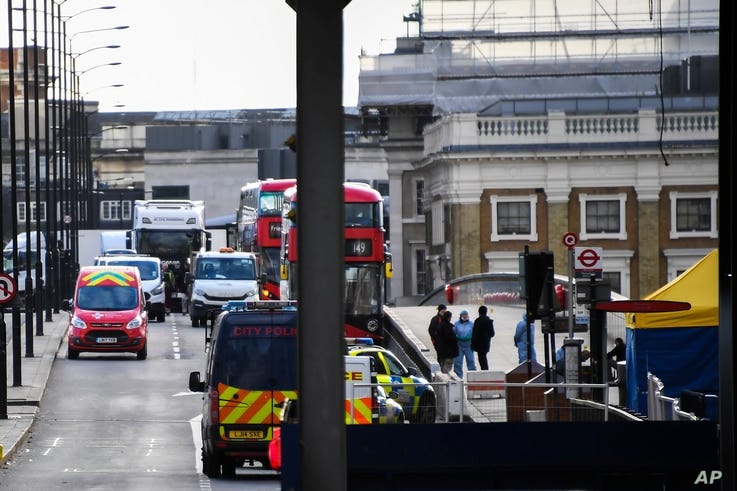 Cars and buses are seen stationary on London Bridge in London, Sunday, Dec. 1, 2019, as police forensic work is completed…