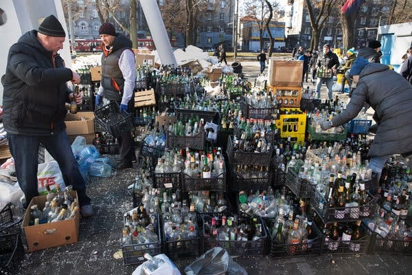 Civilian volunteers sorted empty bottles to be used for Molotov cocktails in a parking lot in Dnipro, Ukraine, on Sunday.