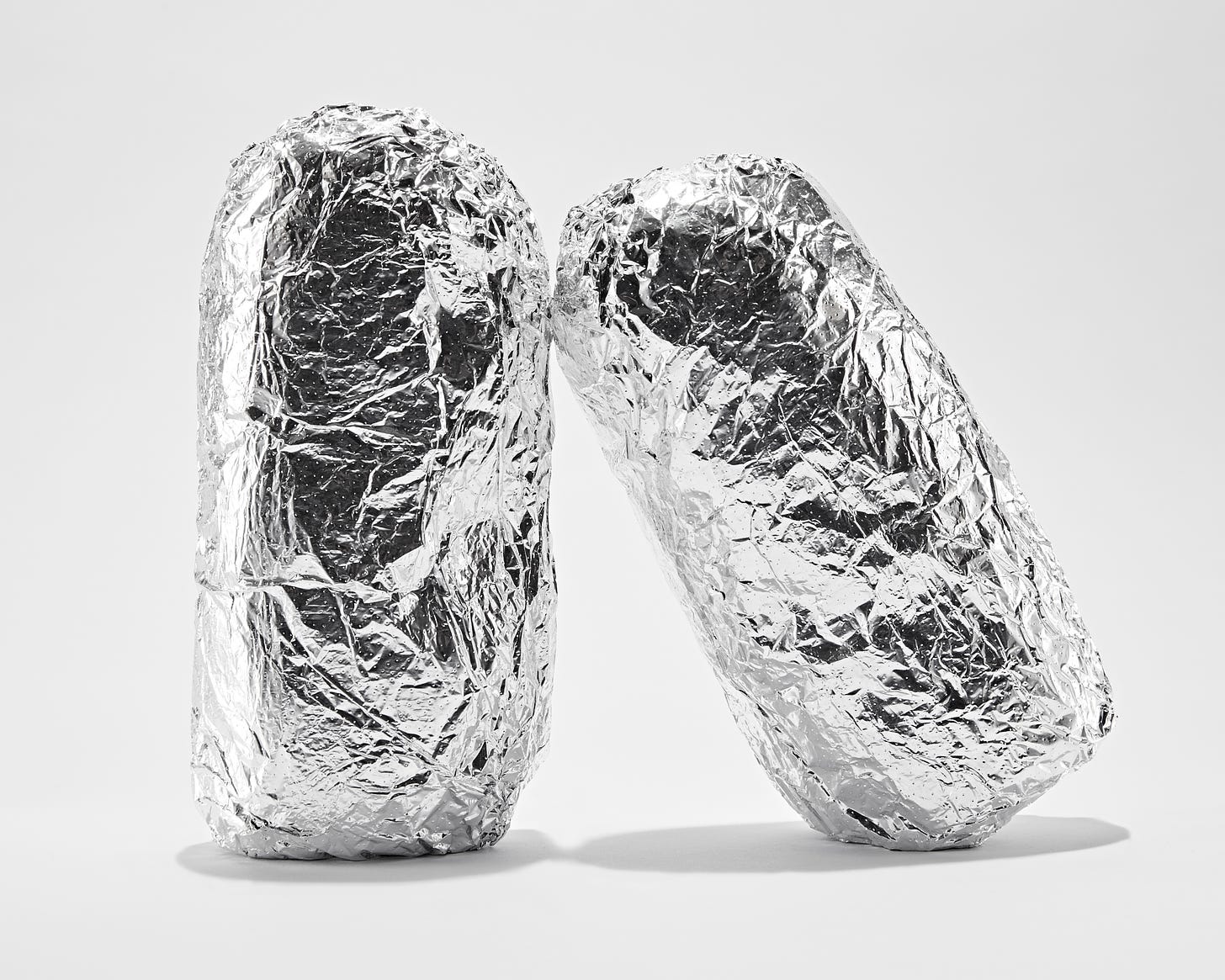 Two foil wrapped subs (I think) standing on end, one leaning on the other in a vaguely humanoid gesture, if that makes sense.