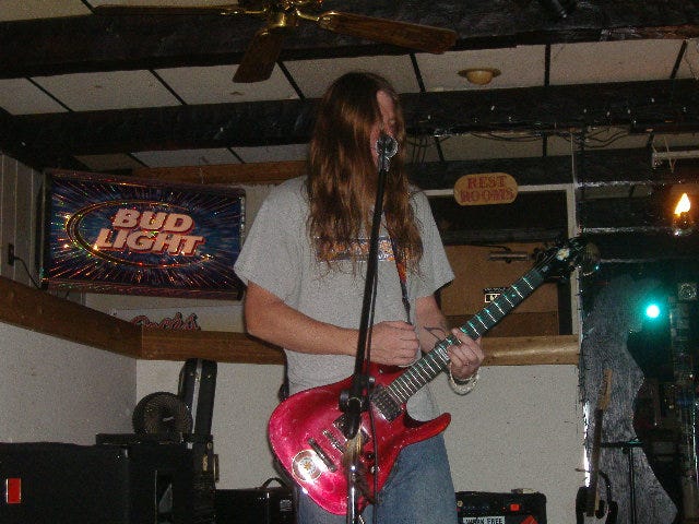 Jim singing and playing his guitar.