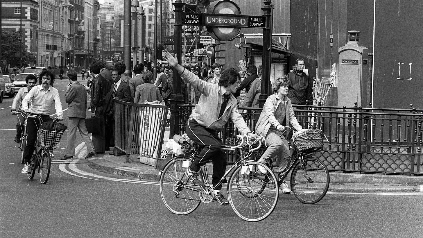 People ride bikes past a closed tube station during a London tube strike in 1982.