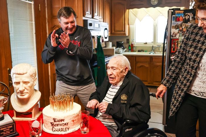 Georgia coach Kirby Smart applauds for Charley Trippi after Trippi blew out all the candles on his cake on his 100th birthday at his home in Athens. Trippi, one of the greatest players and athletes in Bulldogs history, died Wednesday.  (Photo by Tony Walsh/UGA Athletics)