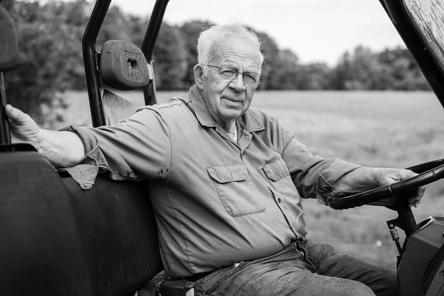 Black and white portrait of an older man in a buggy