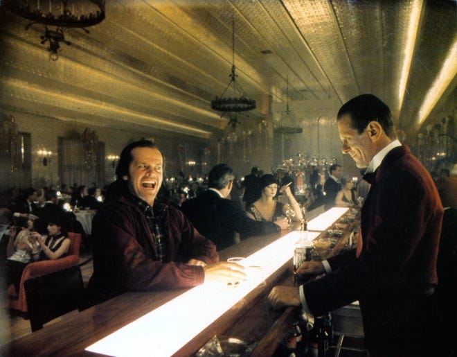 Jack Nicholson with bartender Joe Turkel in lobby card for the film 'The Shining'
