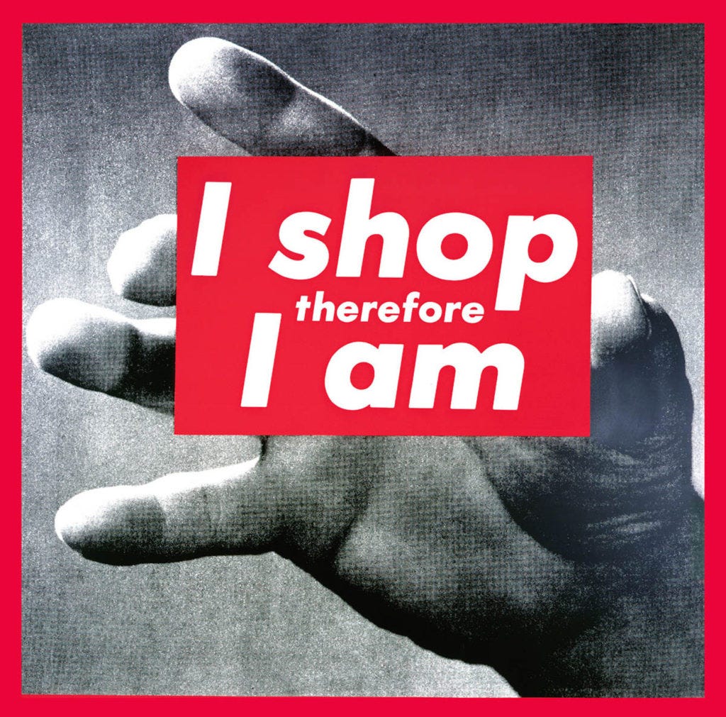 The text 'I shop therefore I am' is superimposed over a black-and-white hand