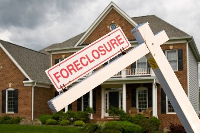 A house with a foreclosure sign
