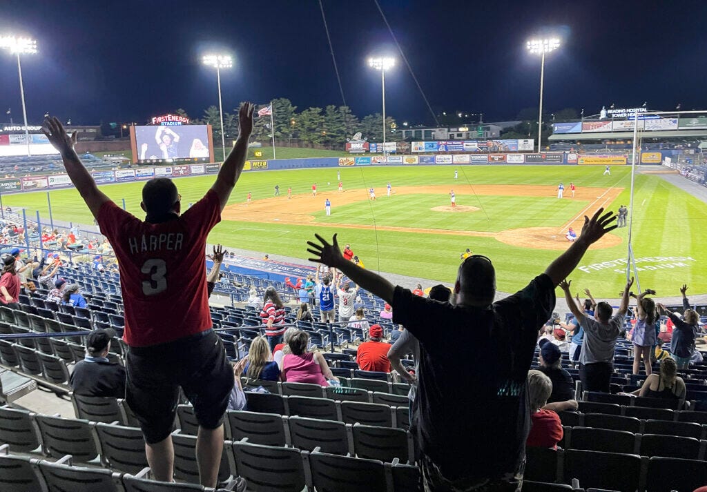 Reading, PA - May 4: Fans in the raise their arms to try to catch items thrown into the stands between innings. During opening night for the Reading Fightin Phils against the Erie Seawolves at First Energy Stadium in Reading Pennsylvania Tuesday evenning May 4, 2021. The Reading Fightin Phils are a Double-A Affiliate of the Philadelphia Phillies. (Photo by Ben Hasty/MediaNews Group/Reading Eagle via Getty Images)