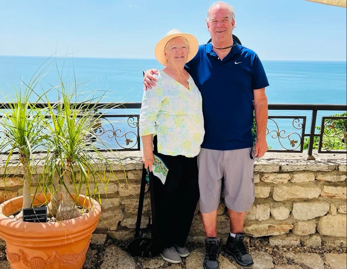 Tom and Georganna standing on an outlook overlooking the Black Sea in Turkey. The ocean behind them is a lovely blue. 