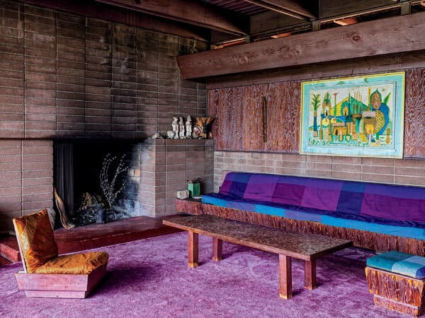 A painting by Jean Varda hangs over a built-in seating platform in the living room.