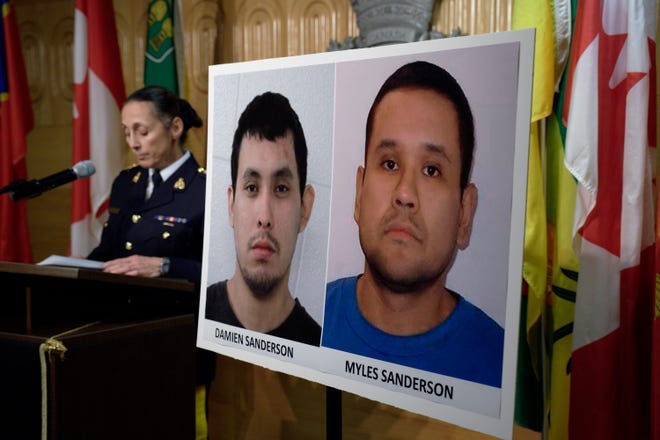 Rhonda Blackmore of the Royal Canadian Mounted Police speaks next to images of the two suspects in a series of fatal stabbings on Sunday in the province of Saskatchewan.