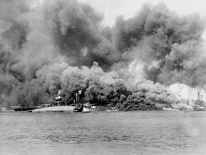 USS Oklahoma capsizes in a photo taken during the attack on Pearl Harbor. Wikipedia.org