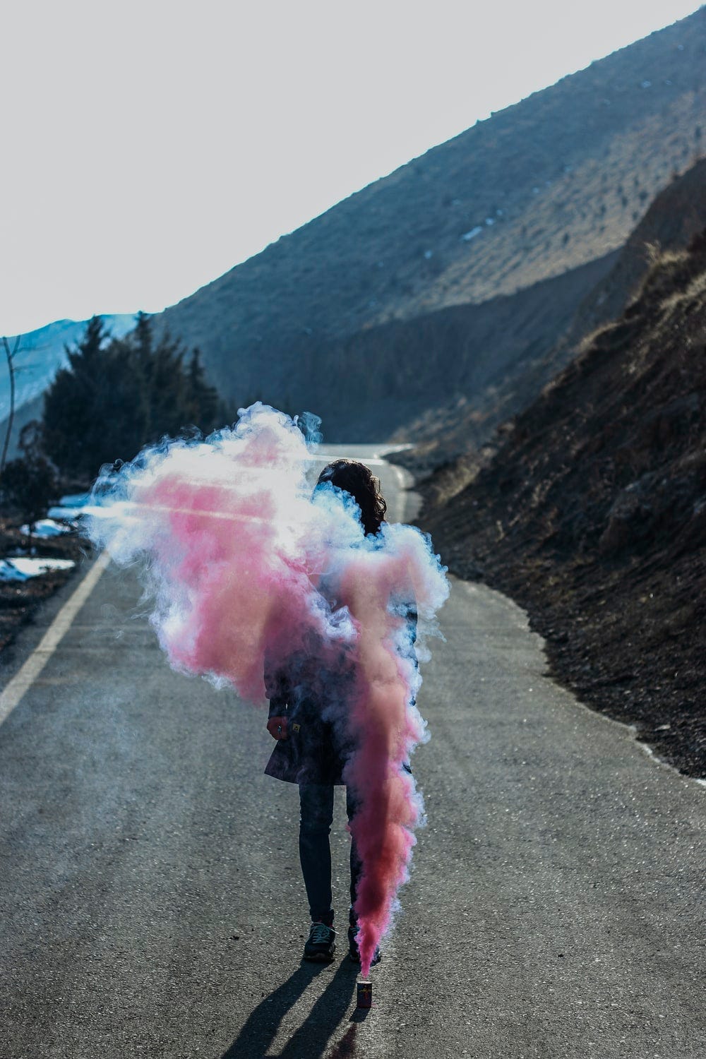 pink smoke coming out from a mountain