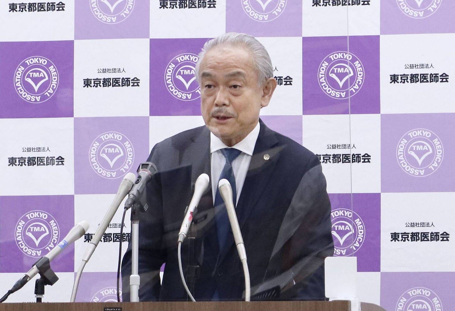 Tokyo Medical Association President Haruo Ozaki speaks to reporters in August. | KYODO
