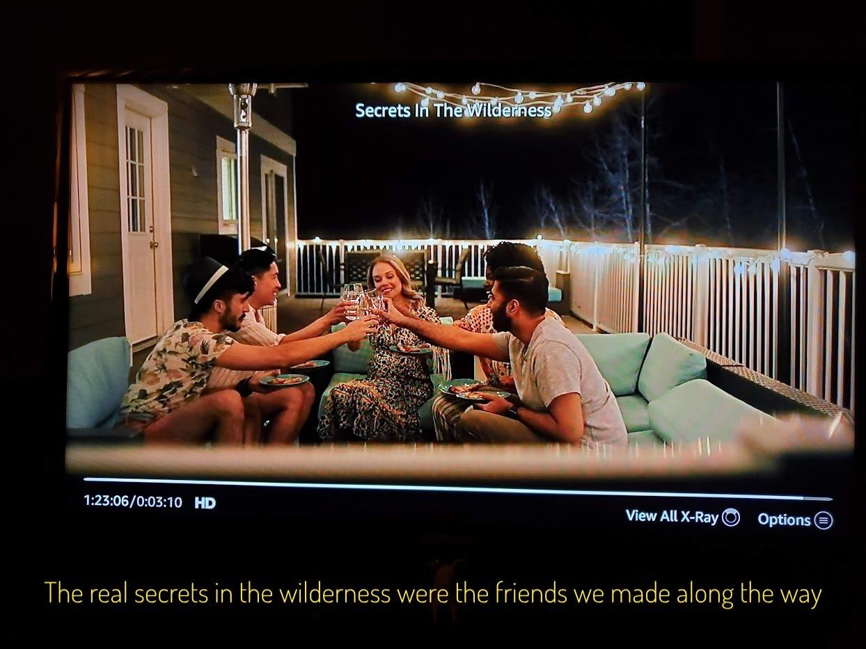 The group toasting each other, captioned "The real secrets in the wilderness were the friends we made along the way"